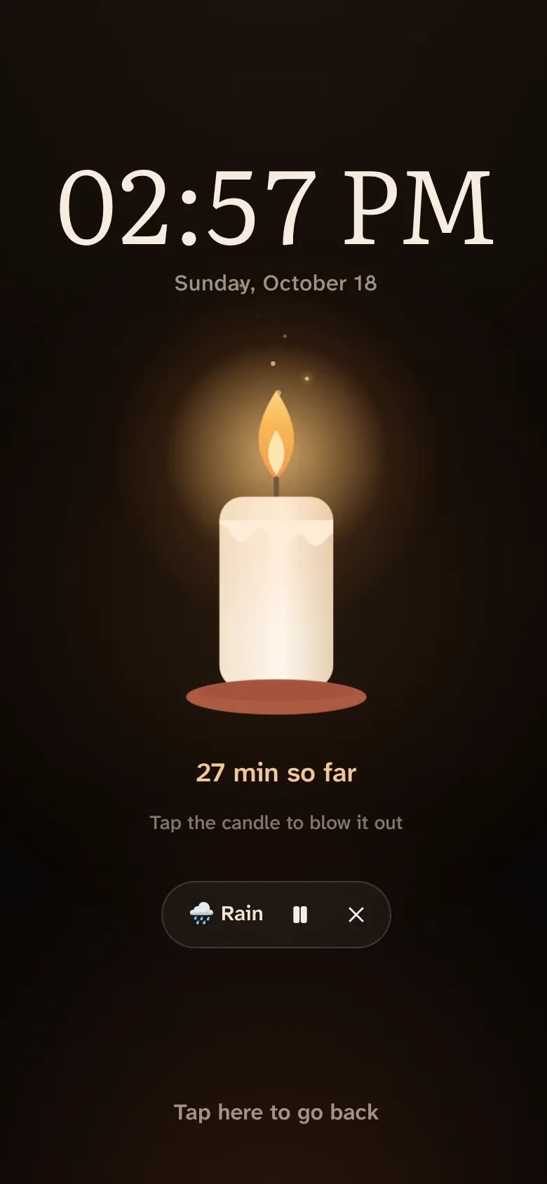 Candle mode: a dark screen with the time and a lit candle